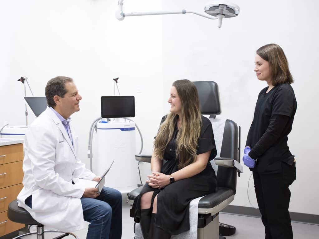 Dr. Joel Schlessinger giving a cosmetic consultation to a female patient.