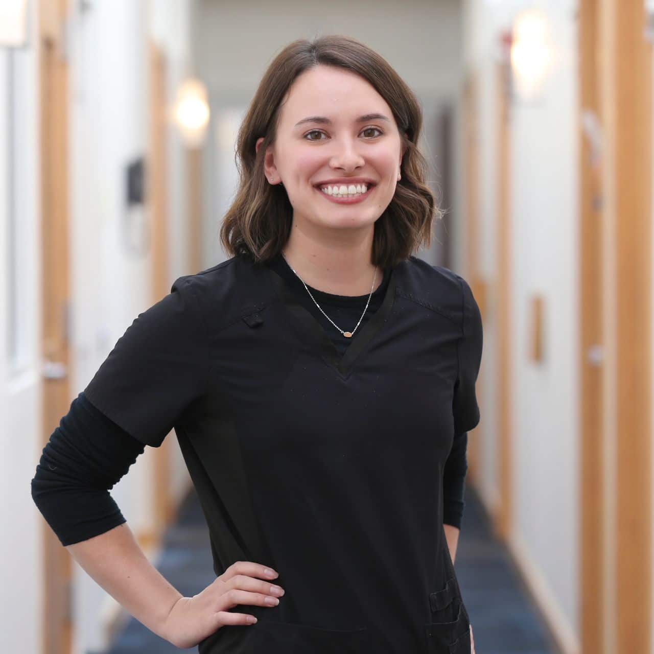 Physician Assistant Lauren Gerace standing in Schlessinger MD Hallway