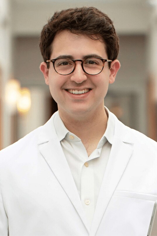 Dr Daniel Standing in Schlessinger MD hallway