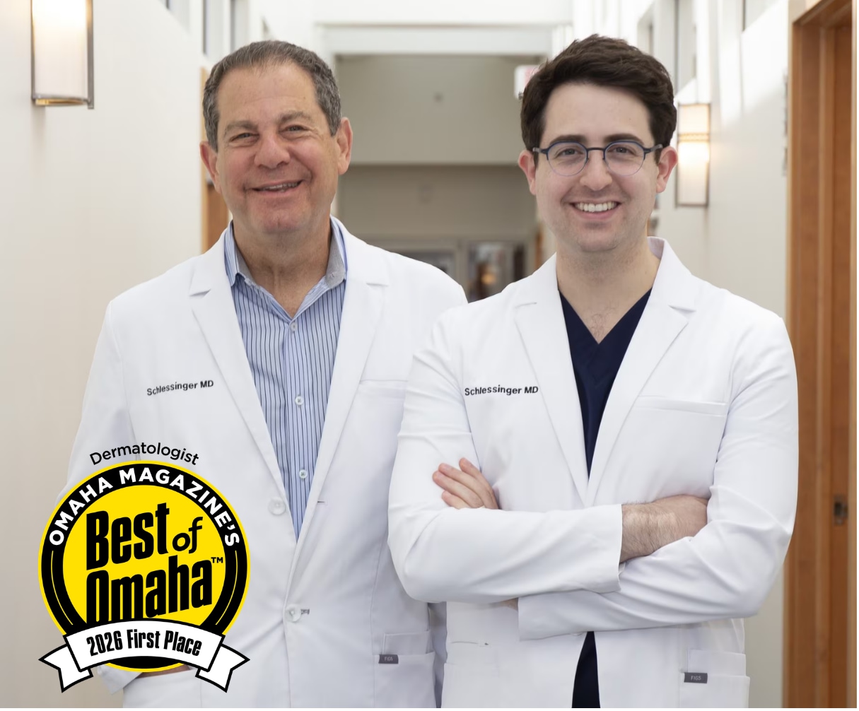 Drs. Joel and Daniel Schlessinger Standing in a hallway with best of omaha 2026 First Place Award placed over them